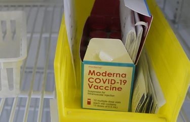 A box of the Moderna COVID-19 vaccine is shown in a cooler, Monday, March 15, 2021, at a Seattle Indian Health Board clinic in Seattle. The SIHB began vaccinating front line staff from Seattle Public Schools Monday, including substitute teachers, custodians, nutrition services staff, special education teachers, and instructional aides, after determining they had enough doses of the vaccine to share with school workers. (AP Photo/Ted S. Warren) OTK OTK
