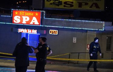 Law enforcement officials confer outside a massage parlor following a shooting on Tuesday, March 16, 2021, in Atlanta. Shootings at two massage parlors in Atlanta and one in the suburbs have left multiple people dead, many of them women of Asian descent, authorities said Tuesday. (AP Photo/Brynn Anderson) GABA205 GABA205