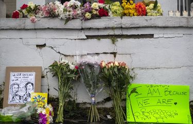 Flowers and signs are displayed at a makeshift memorial outside of the Gold Spa in Atlanta, Wednesday, March 17, 2021. Police in the Atlanta suburb of Gwinnett County say they’ve begun extra patrols in and around Asian businesses there following the shooting at three massage parlors in the area that killed eight, most of them women of Asian descent. (Alyssa Pointer/Atlanta Journal-Constitution via AP) GAATJ503 GAATJ503