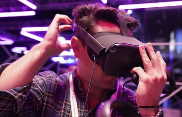 An attendee tries on the Oculus Quest VR headset at F8, the Facebook’s developer conference, Tuesday, April 30, 2019, in San Jose, Calif. (AP Photo/Tony Avelar )