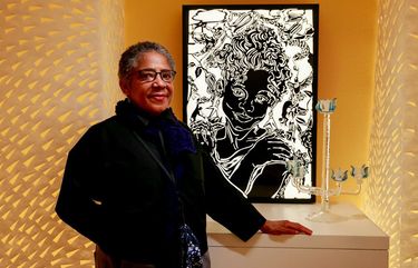 Seattle-based artist Barbara Earl Thomas is photographed next to her glass portrait, “Baileh, 2020” inside her exhibition ‘The Geography of Innocence’ at the Seattle Art Museum Monday, March 15, 2021. 216627