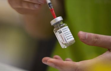 A pharmacist prepares to fill a syringe from a vial of the AstraZeneca COVID-19 vaccine at the Vaccine Village in Antwerp, Belgium on Tuesday, March 16, 2021. Belgium on Tuesday reaffirmed its support to AstraZeneca vaccines and said it will keep using it in its current vaccination campaign, amid raising concerns over its side effects and with growing number of EU countries deciding to protectively stop using it. (AP Photo/Virginia Mayo) OTK107 OTK107
