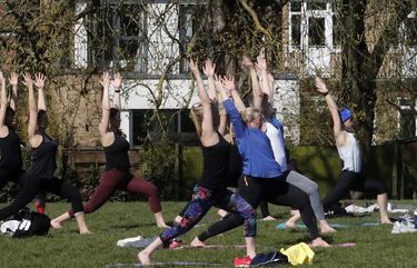 A goup of women enjoys exercising in a park following the easing of England’s Coronavirus lockdown to allow far greater freedom outdoors in London, Monday, March 29, 2021. England is embarking on a major easing of its latest coronavirus lockdown that came into force at the start of the year, with families and friends able to meet up in outdoor spaces and many sports permitted once again. Under Monday’s easing, groups of up to six, or two households, can socialize in parks and gardens once more, while outdoor sports facilities can reopen after the stark stay-at-home order, which has seen new coronavirus cases fall dramatically over the past three months, ended. (AP Photo/Frank Augstein) FAS114 FAS114