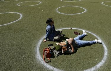 FILE – In this March 3, 2021, file photo, Kyree Kayoshi, his dog Kumi, and Miranda De Llano use circles marked for social distancing to help battle the COVID-19 virus as they relax at the Pearl Brewery in San Antonio. (AP Photo/Eric Gay, File) NYAG301 NYAG301