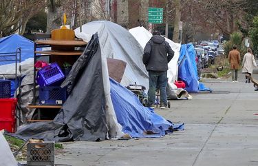 At Ballard Commons Park, tents surround and are in the park.
Researchers at SPU, UW, have conducted a “tent census” of the city in summer 2019, resampling that winter and then after the pandemic hit, and found that in 2019 the city had more than 800 tents, and in populated areas they increased more than 50 percent after the pandemic hit. 216741