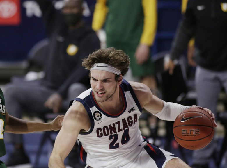 Gonzaga forward Corey Kispert, right, dribbles while pressured by San Francisco guard Khalil Shabazz during the first half of an NCAA college basketball game in Spokane, Wash., Saturday, Jan. 2, 2021. (Young Kwak / AP)