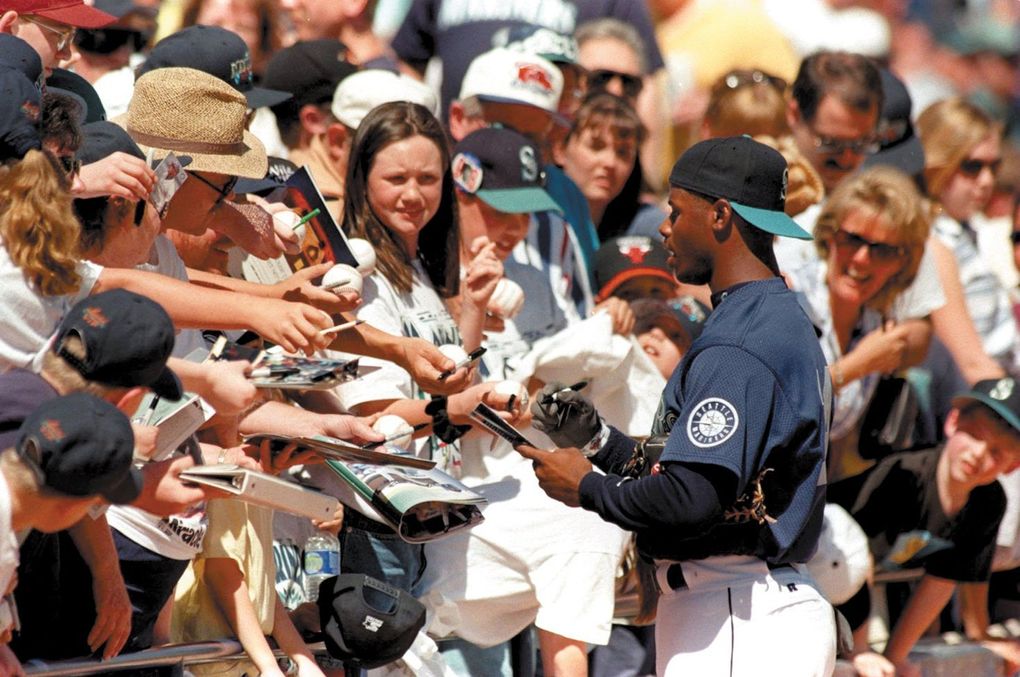 Ken Griffey Jr. hands fans, mainly kids, autographs during spring training in 1996. (Mark Harrison / The Seattle Times)