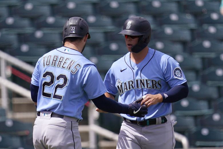 Seattle Mariners' Ty France watches the flight of his run-scoring