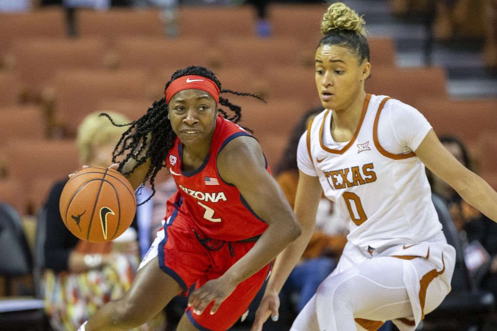 In this Nov. 17, 2019, file photo, Arizona guard Aari McDonald (2) drives around Texas guard Celeste Taylor (0) during an NCAA college basketball game in Austin, Texas. McDonald is the first preseason All-American at her school. (Stephen Spillman / AP)