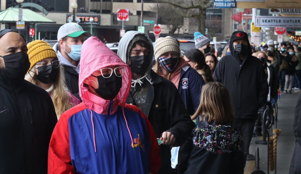A seemingly endless line waits to enter the Starbucks in the Pike Place Market on Saturday. Phase 3 is coming but the Pike Place Market already has many crowded spots. (Alan Berner / The Seattle Times)