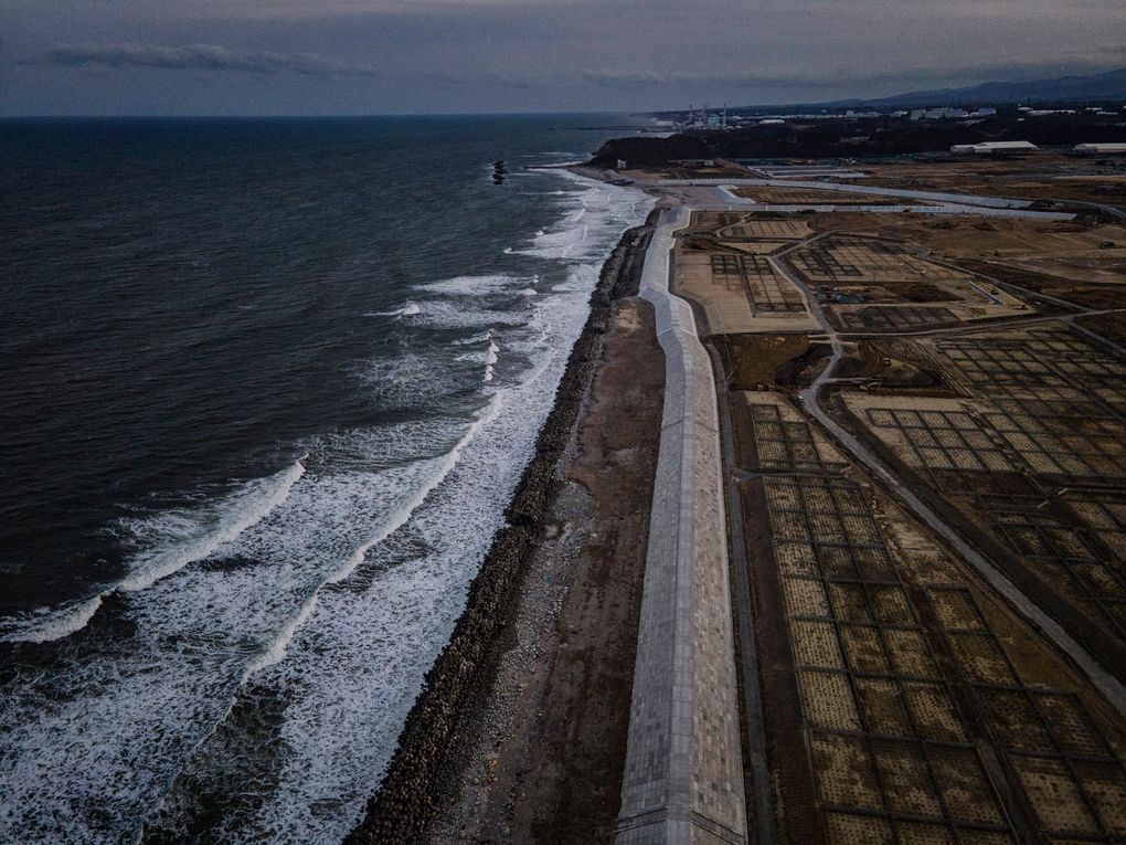 A new sea wall rises along the Pacific, near the crippled Fukushima Daiichi nuclear power plant in the distance, in Japan’s Fukushima Prefecture, March 4, 2021. (James Whitlow Delano/The New York Times)