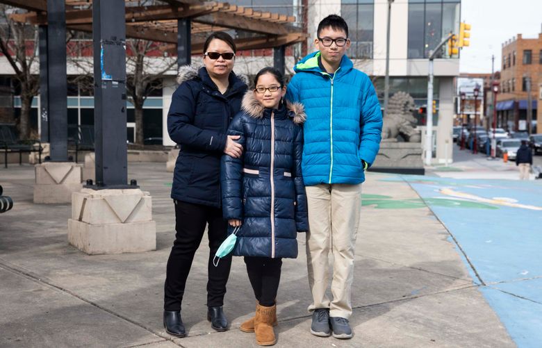 Nancy Lin, left, with her kids, Miranda Gao, 12, and Stanley Gao, 13, in Philadelphia. She decided to maintain their remote education because of issues with a school building’s condition. Rachel Wisniewski for The Washington Post.