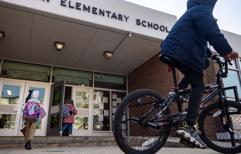 Students arrive at Harriet Tubman Elementary School in the Washington, D.C. for in-person instruction on March 9. MUST CREDIT: Washington Post photo by Evelyn Hockstein