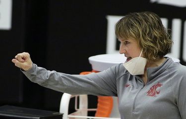 Washington State head coach Kamie Ethridge signals her team during the first half of an NCAA college basketball game against UCLA in Pullman, Wash., Friday, Feb. 5, 2021. (AP Photo/Young Kwak)