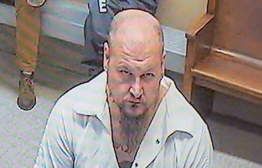 On a video monitor in a Spokane County Superior Court courtroom, Raymond Bryant, left, gives a not guilty plea during his arraignment to Judge Julie McKay, not pictured on lower right, on the charge of harassment stemming from racist graffiti found on Temple Beth Shalom, Tuesday, Mar. 2, 2021, in Spokane, Wash. (Jesse Tinsley/The Spokesman-Review via AP) WASPO101 WASPO101