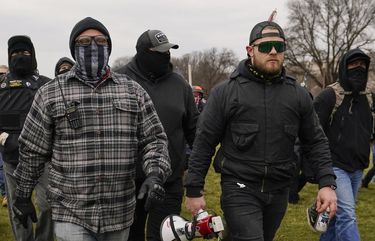 In this Jan. 6, 2021, photo, Proud Boy members Joseph Biggs, left, and Ethan Nordean, right with megaphone, walk toward the U.S. Capitol in Washington, in support of President Donald Trump. The Proud Boys and Oath Keepers make up a fraction of the more than 300 Trump supporters charged so far in the siege that led to Trump’s second impeachment and resulted in the deaths of five people, including a police officer. But several of their leaders, members and associates have become the central targets of the Justice Departmentâ€™s sprawling investigation. (AP Photo/Carolyn Kaster) WX201 WX201