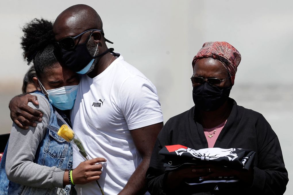 Family members attend the burial of Sgt. Jorge Luis Pereira da Silva, 54, who died from COVID-19, at the Campo da Esperanca cemetery in Brasilia, Brazil, Tuesday, March 23, 2021. The nation had an average of 2,235 deaths a day last week – the highest since the beginning of the pandemic. (AP Photo/Eraldo Peres)
