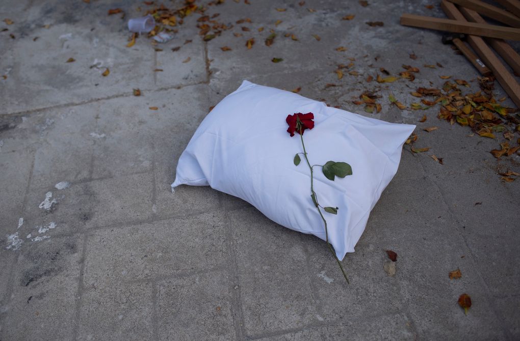 A pillow with a rose sits on the sidewalk during a protest against the Government’s handling of the COVID-19 pandemic, organized by the Rio de Paz NGO in front of the Ronaldo Gazolla hospital in Rio de Janeiro, Brazil, Wednesday, March 24, 2021. (AP Photo/Silvia Izquierdo)