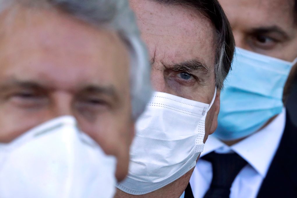 Brazilian President Jair Bolsonaro, center, arrives for a press conference following a meeting about the federal government’s response to the COVID-19 pandemic at the presidential residence Alvorada Palace in Brasilia, Brazil, Wednesday, March 24, 2021. In recent weeks, Latin America’s largest country has become the pandemic’s global epicenter, with more deaths from the virus each day than in any other nation. (AP Photo/Eraldo Peres)