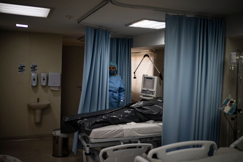 The body of a COVID-19 victim lies in a body bag at the ICU of the Sao Jose municipal hospital in Duque de Caxias, Brazil, Wednesday, March 24, 2021. (AP Photo/Felipe Dana)