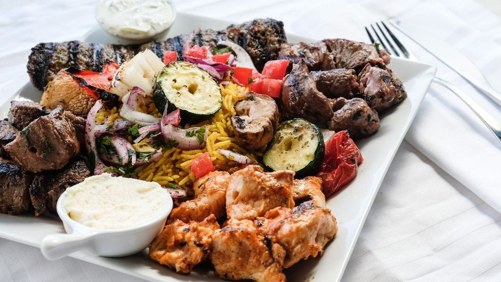 Food critic Tan Vinh raves about the $59 family meal deal at the new Lebanese restaurant Tanoor in South Lake Union, a medley of meat and veggie kebabs over yellow rice. It comes with three sides, pita and dipping sauces. (Courtesy of Tanoor)
