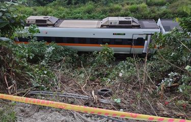 A section of a derailed train is seen cordoned off near the Taroko Gorge area in Hualien, Taiwan on Friday, April 2, 2021. The train partially derailed in eastern Taiwan on Friday after colliding with an unmanned vehicle that had rolled down a hill, killing dozens. With the train still partly in a tunnel, survivors climbed out of windows and walked along the train’s roof to reach safety after the country’s deadliest railway disaster. (AP Photo/Chiang Ying-ying) XHG301 XHG301