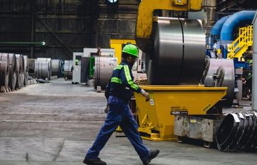 A finished steel coil is lifted and moved at the NLMK Pennsylvania plant in Farrell, Pennsylvania, U.S., on Thursday, Sept. 19, 2019. U.S. raw steel production rose to 1.48 million tons from 1.446 million tons a week earlier, the American Iron and Steel Institute said in an email. Photographer: Allison Farrand/Bloomberg