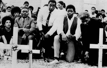 Charles Evers, civil rights leader (left center in tie) was among 3,000 persons who marched on the Jackson State College campus in Jackson, Miss., yesterday as part of a memorial service for two young Negroes killed by police gunfire there. Students placed crosses in the courtyard of the dormitory where the shooting took place. The third cross is for Benjamin Brown killed by police three years ago during a civil-rights emonstration there. ( / A.P.)