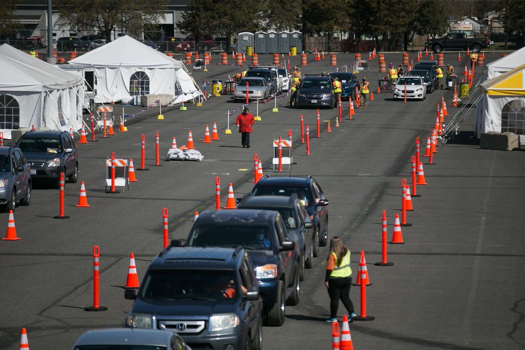 Motorists wait in their vehicles as they wait their turn to be inoculated with a COVID-19 vaccine at the Pilot Community Vaccination Center in the State Fair Park’s parking lot in Yakima, Wash. (Amanda Ray / Yakima Herald-Republic)