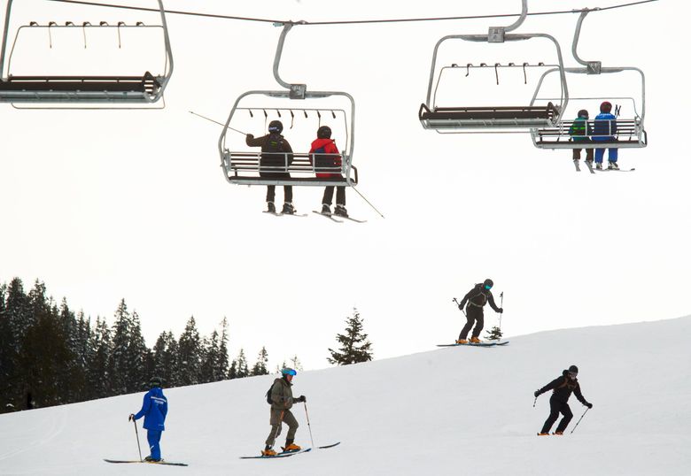 Skiers and snowboarders recreate at Stevens Pass ski area in the Cascade Mountains March 9, 2021. (Erika Schultz / The Seattle Times)