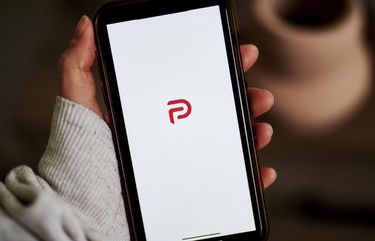 The Parler logo on a smartphone arranged in the Brooklyn borough of New York, U.S., on Friday, Dec. 18, 2020. Parler bills itself as a non-biased social network that protects free speech and user data. John Matze, chief executive officer, says the platform saw great growth during the 2020 election as many conservatives moved away from products like Facebook and Twitter.  Photographer: Gabby Jones/Bloomberg