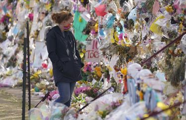 Tributes hang on the temporary fence surrounding the parking lot in front of a King Soopers grocery store in which 10 people died in a late March mass shooting Friday, April 9, 2021, in Boulder, Colo. (AP Photo/David Zalubowski) OTKDZ152 OTKDZ152
