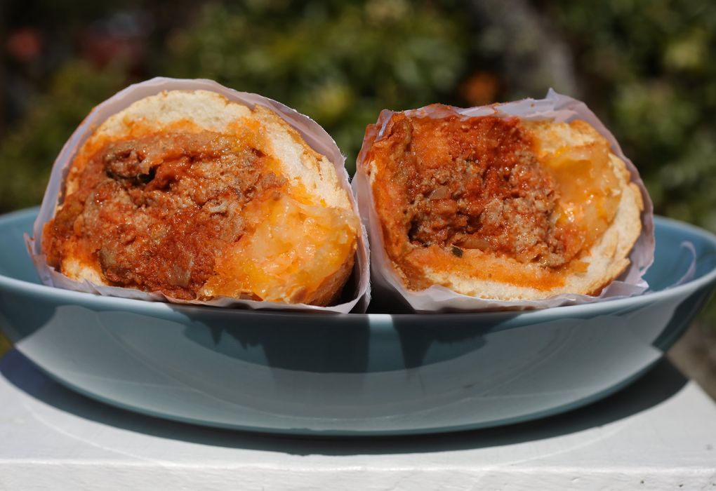 Good Day Donuts in White Center offers a $9 pork-and-beef-meatball sub with a melted medley of mozzarella, cheddar and Monterey Jack served on banh mi bread. (Ken Lambert / The Seattle Times)