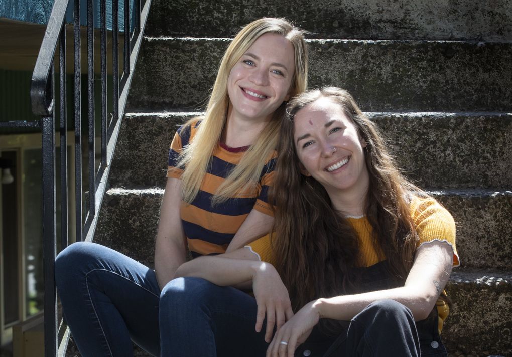 Leah Caglio, left, and Sally Neumann, sitting at Leah’s Seattle home April 20, are best friends who also happen to be “Jeopardy!” contestants. They have opened a small trivia business together to try and capitalize on their shared love of the game. The Seattle area has a large number of “Jeopardy!” alumni (including, of course, Ken Jennings). (Ellen M. Banner / The Seattle Times)