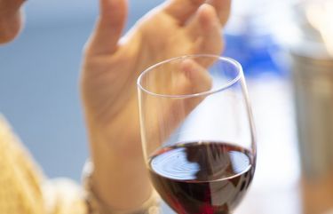 FILE — Tasting a red wine in New York on Sept. 26, 2019. Moderate drinking is unlikely to impair the immune response to the COVID-19 vaccine, but heavy drinking might. (Tony Cenicola/The New York Times)