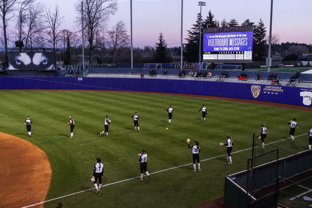 The Husky Softball diamond is made ready to play for a game on Friday, March 12 — one year after COVID-19 shut down athletics everywhere. (Dean Rutz / The Seattle Times)