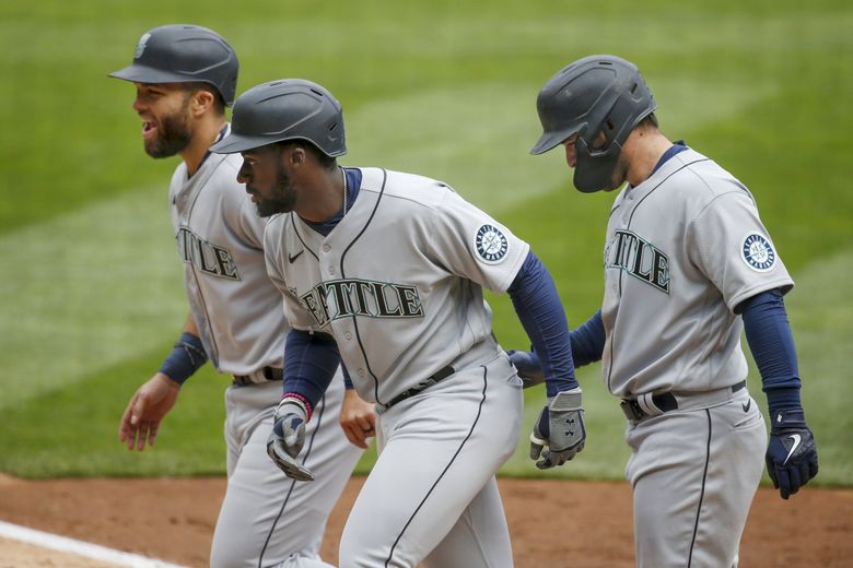 Seattle Mariners' Kyle Seager watches his three-run double against