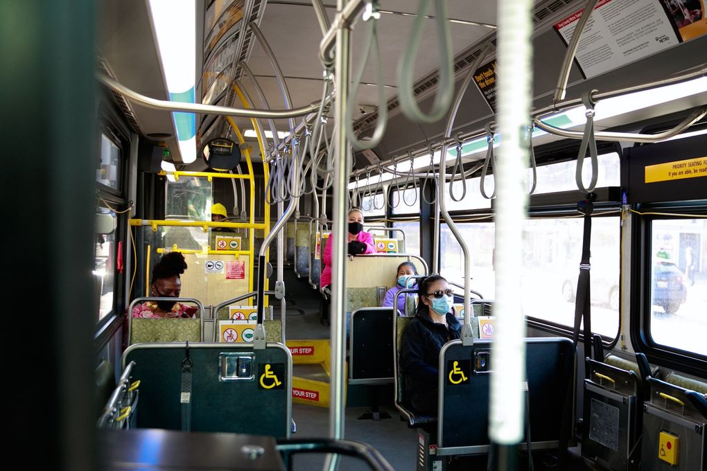 Only a handful of people ride a Metro bus in the Chinatown-International District on April 21. Transit officials predict ridership will rebound, but it’s unclear how soon and by how much. (Erika Schultz / The Seattle Times)