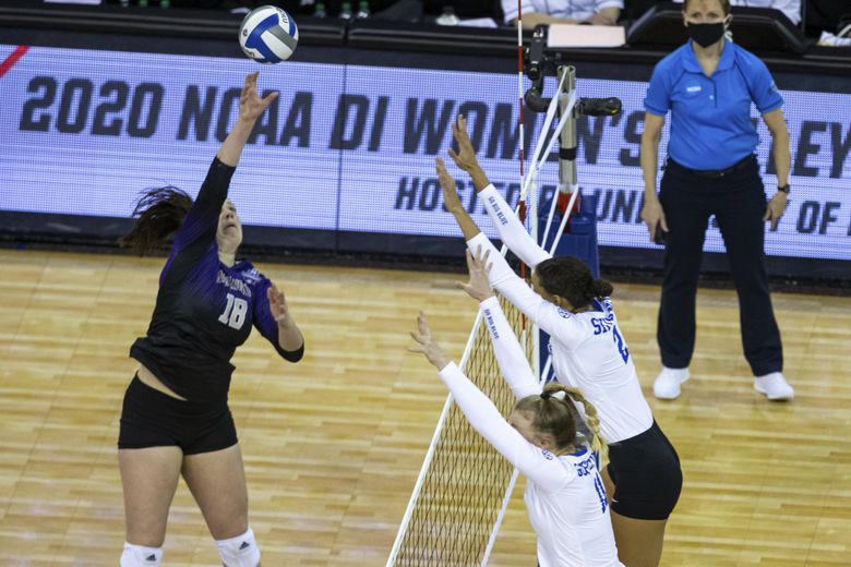Washington outside hitter Madi Endsley (18) spikes the ball against Kentucky’s Elise Goetzinger (11) and Madi Skinner (2) during the first set of a semifinal in the NCAA women’s volleyball championships Thursday, April 22, 2021, in Omaha, Neb. (John Peterson / The Associated Press)