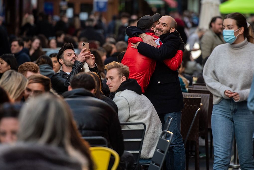 FILE: Two men embrace amongst people drinking outside in Soho as non essential retail reopens on April 12, 2021 in London, United Kingdom. England has taken a significant step in easing its lockdown restrictions, with non-essential retail, beauty services, gyms and outdoor entertainment venues among the businesses given the green light to re-open with coronavirus precautions in place. Pubs and restaurants are also allowed open their outdoor areas, with no requirements for patrons to order food when buying alcoholic drinks. (Chris J Ratcliffe/Getty Images Europe)