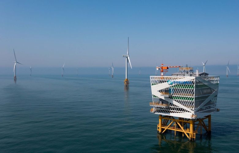 Wind turbines manufactured by Doosan Heavy Industries & Construction Co. and the offshore substation stand at the Korea Offshore Wind Power wind farm in Buan, South Korea, on Thursday, March 25, 2021. MUST CREDIT: Bloomberg photo by SeongJoon Cho.