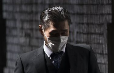 FILE – In this March 4, 2021, file photo, a man wearing a face mask walks on a street during lunchtime in Tokyo. Japan on Friday, April 23, declared a state of emergency to curb a rapid coronavirus resurgence, the third since the pandemic began. The measures in parts of Japan, including Tokyo, have so far failed to curb infections caused by a more contagious new variant of the virus.(AP Photo/Hiro Komae, File) TKSJ305 TKSJ305