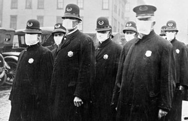 Policemen in Seattle wearing masks made by the Red Cross, during the influenza epidemic in December 1918. Credit: Courtesy National Archives