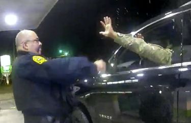 In this image made from Windsor, (Va.) Police video, A police officer uses a spray agent on Caron Nazario on Dec. 20, 2020, in Windsor, Va.  Nazario, a second lieutenant in the U.S. Army, is suing two Virginia police officers over a traffic stop during which he says the officers drew their guns and pointed them at him as he was dressed in uniform. Caron Nazario says his constitutional rights were violated by the traffic stop in the town of Windsor in December.  (Windsor Police via AP) AX901 AX901