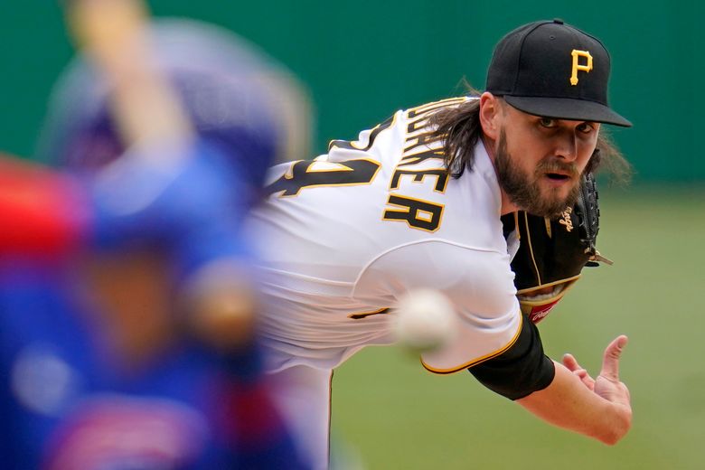 Pittsburgh Pirates starting pitcher JT Brubaker, left, tags out