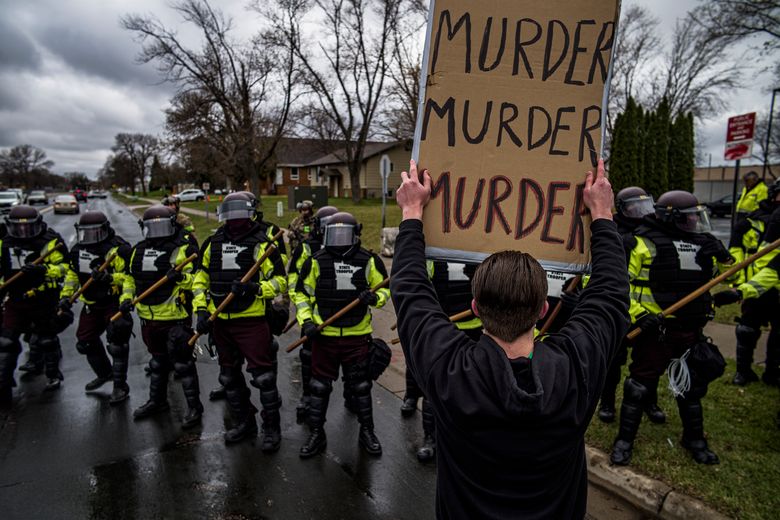 Protesters confront police over the shooting death of Daunte Wright at a rally at the Brooklyn Center Police Department in Brooklyn Center, Minn., on Monday. (Richard Tsong-Taatarii/Star Tribune via AP)