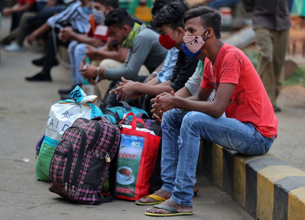 Travelers wait for outstation trains after authorities imposed a two-week lockdown to curb the rising number of COVID-19 cases in Bengaluru, India, Wednesday, April 28, 2021. (AP Photo/Aijaz Rahi)