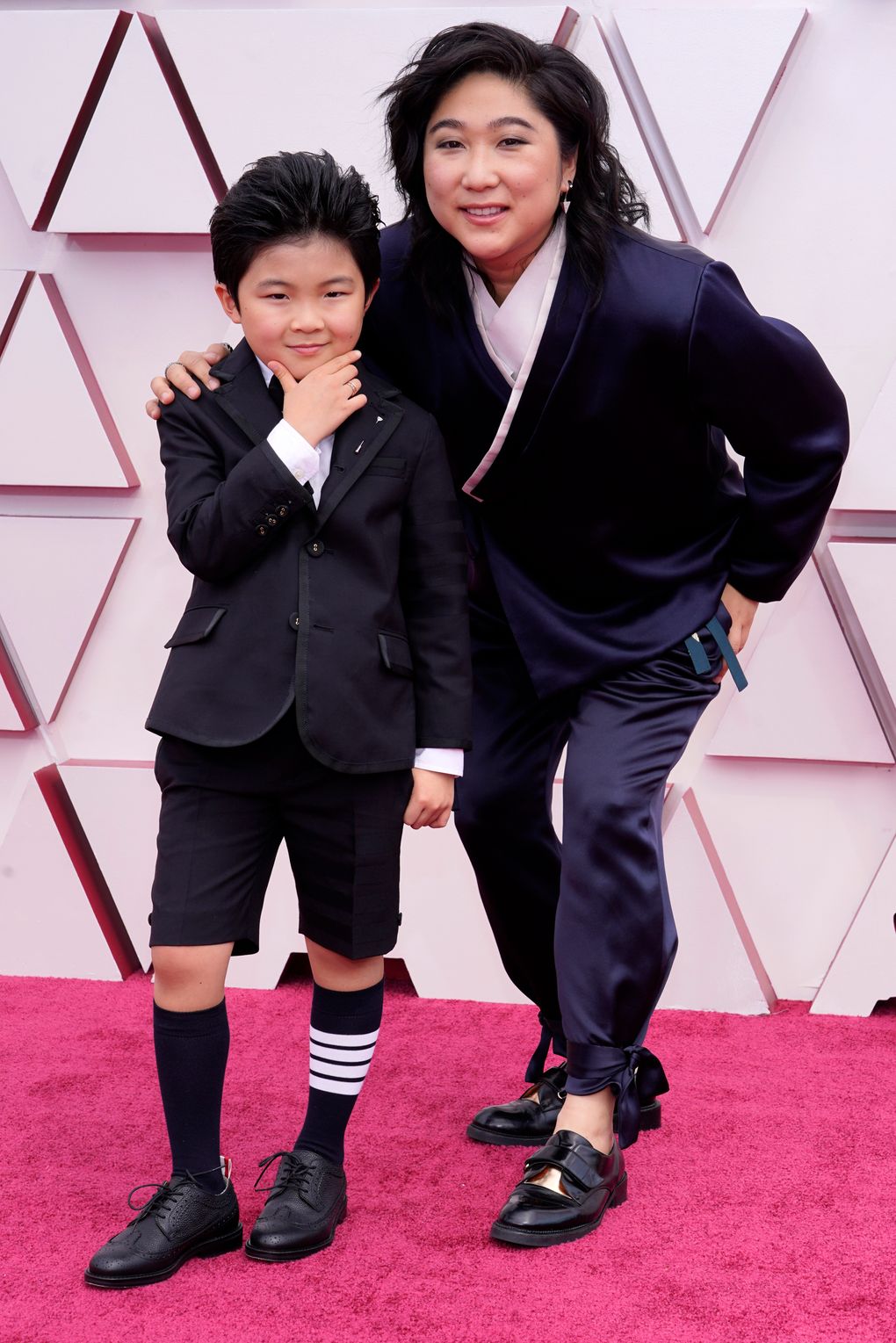 Alan S. Kim, left, and “Minari” producer Christina Oh arrive at the Oscars on Sunday, April 25, 2021, at Union Station in Los Angeles. (AP Photo/Chris Pizzello, Pool)