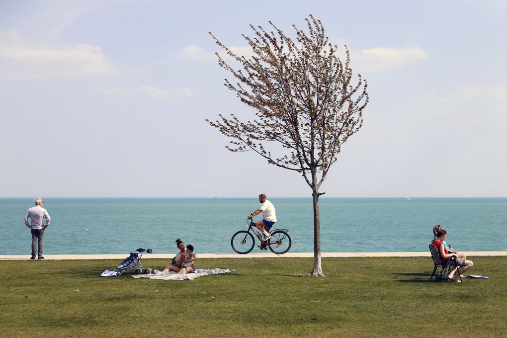 People take advantage of warm spring weather along Lake Michigan on April 27, 2021, at Montrose Beach in Chicago. The CDC’s new guidelines for what vaccinated people can safely do is open to interpretation. More than a year into this, we’re still trying to perform complicated risk calculations. And risk analysis is not something humans are necessarily good at. (Shafkat Anowar / The Associated Press)