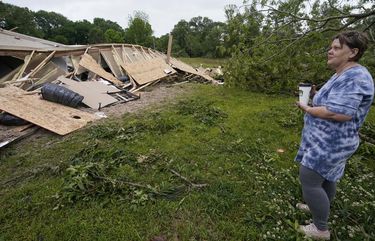 Vickie Savell looks at the remains of her new mobile home early Monday, May 3, 2021, in Yazoo County, Miss. Multiple tornadoes were reported across Mississippi on Sunday, causing some damage but no immediate word of injuries. (AP Photo/Rogelio V. Solis) MSRS101 MSRS101